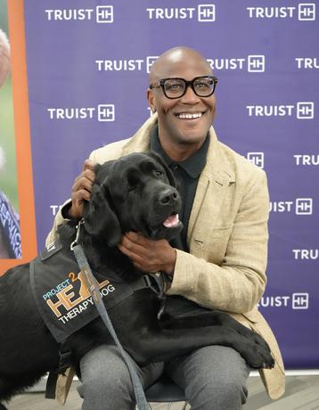 Allyn Shaw with a Project 2 Heal therapy dog at a Truist event