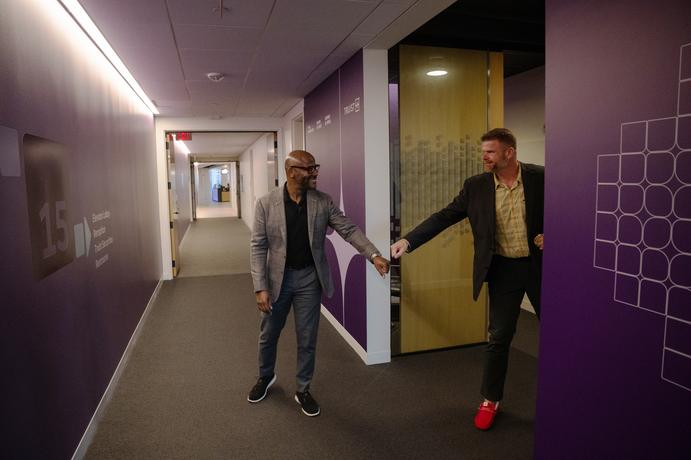 Allyn Shaw sharing a fist bump with a colleague in a Truist hallway