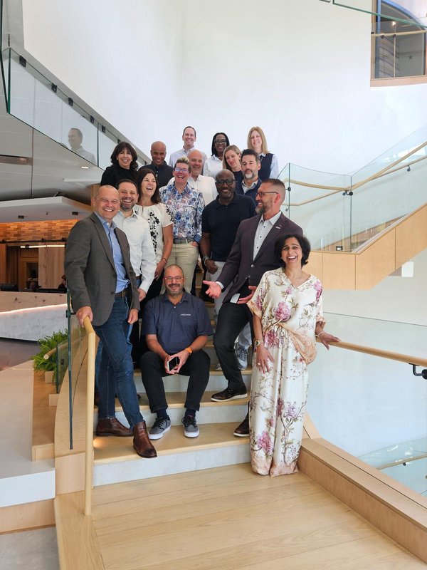Allyn Shaw with leadership colleagues gathered on a staircase